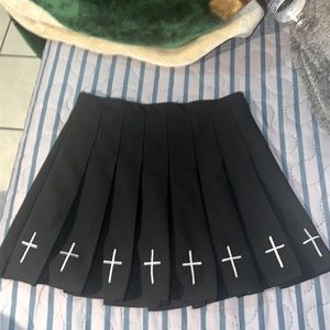 It’s a skirt with crosses on the bottom, black, Medium, has shorts under.